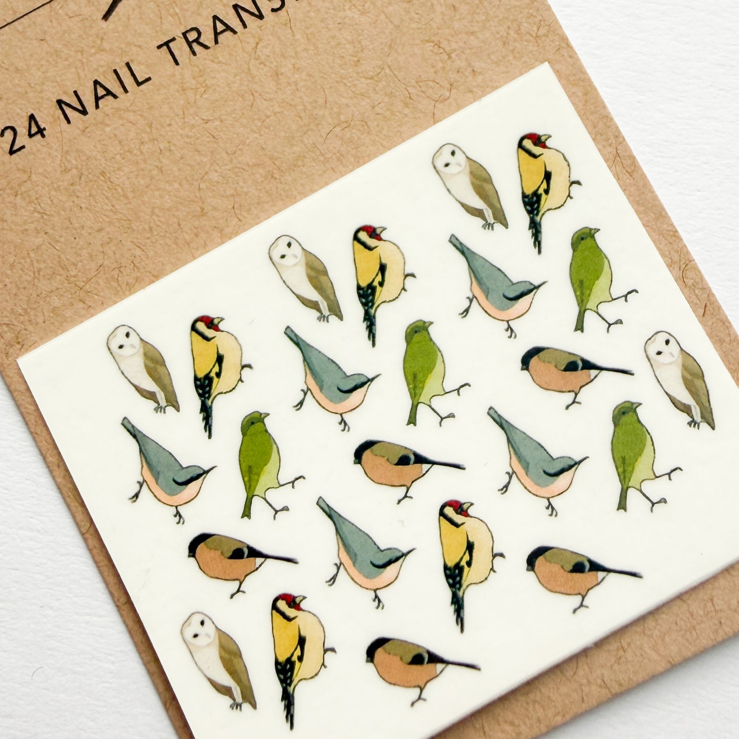 Sheet of bird-themed nail art transfers on a cardboard backing