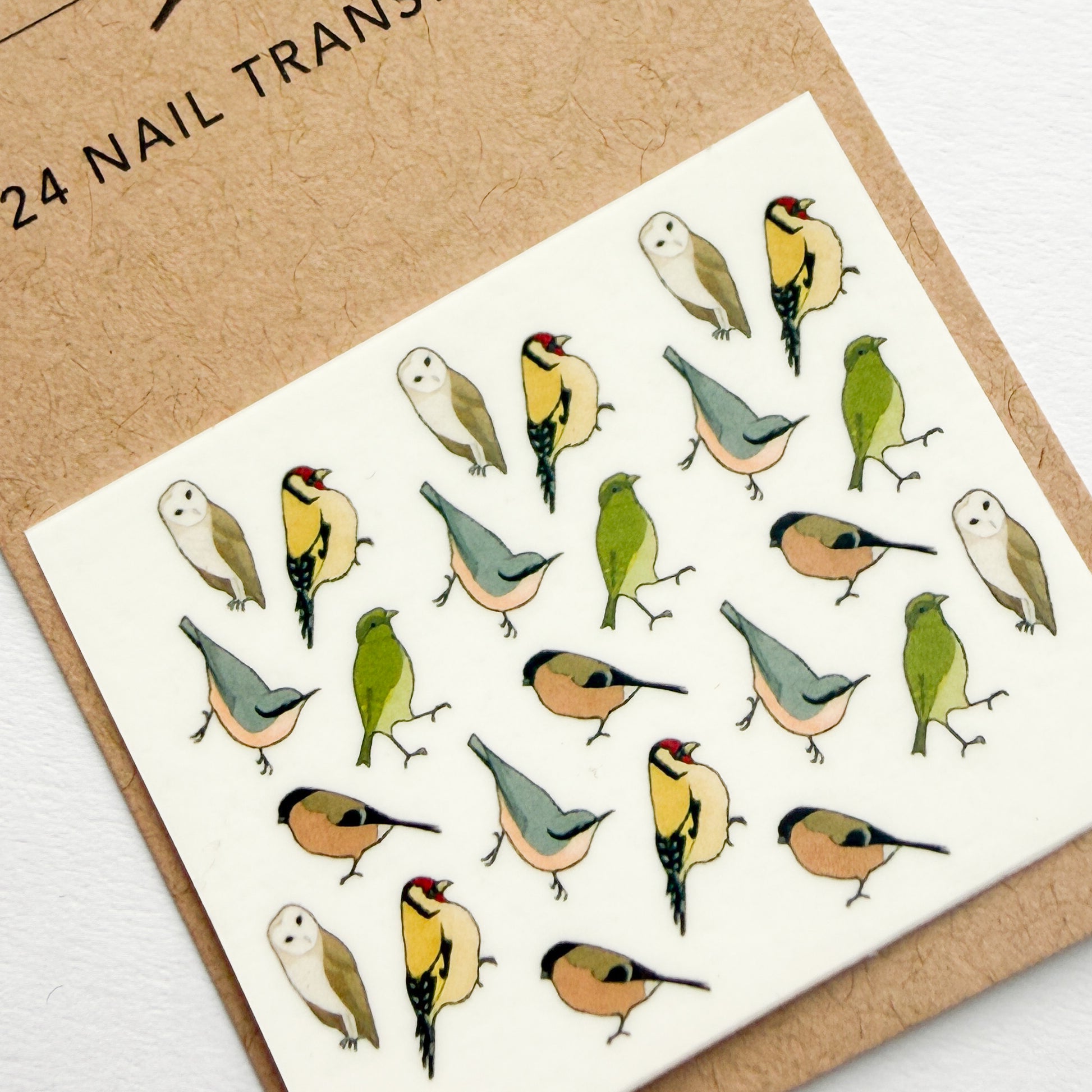 Sheet of bird-themed nail art transfers on a cardboard backing