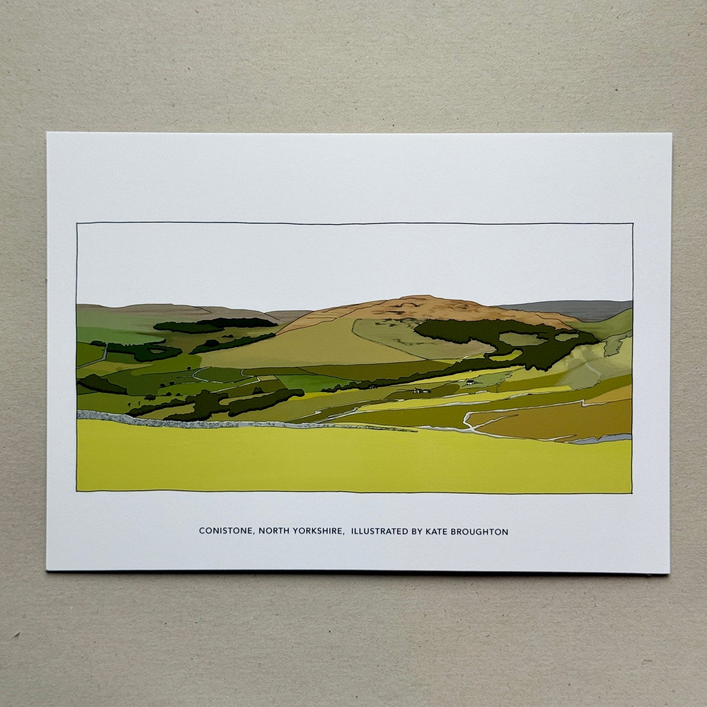 Art print of a landscape with green fields and a hill on a beige background. Labelled Conistone, North Yorkshire