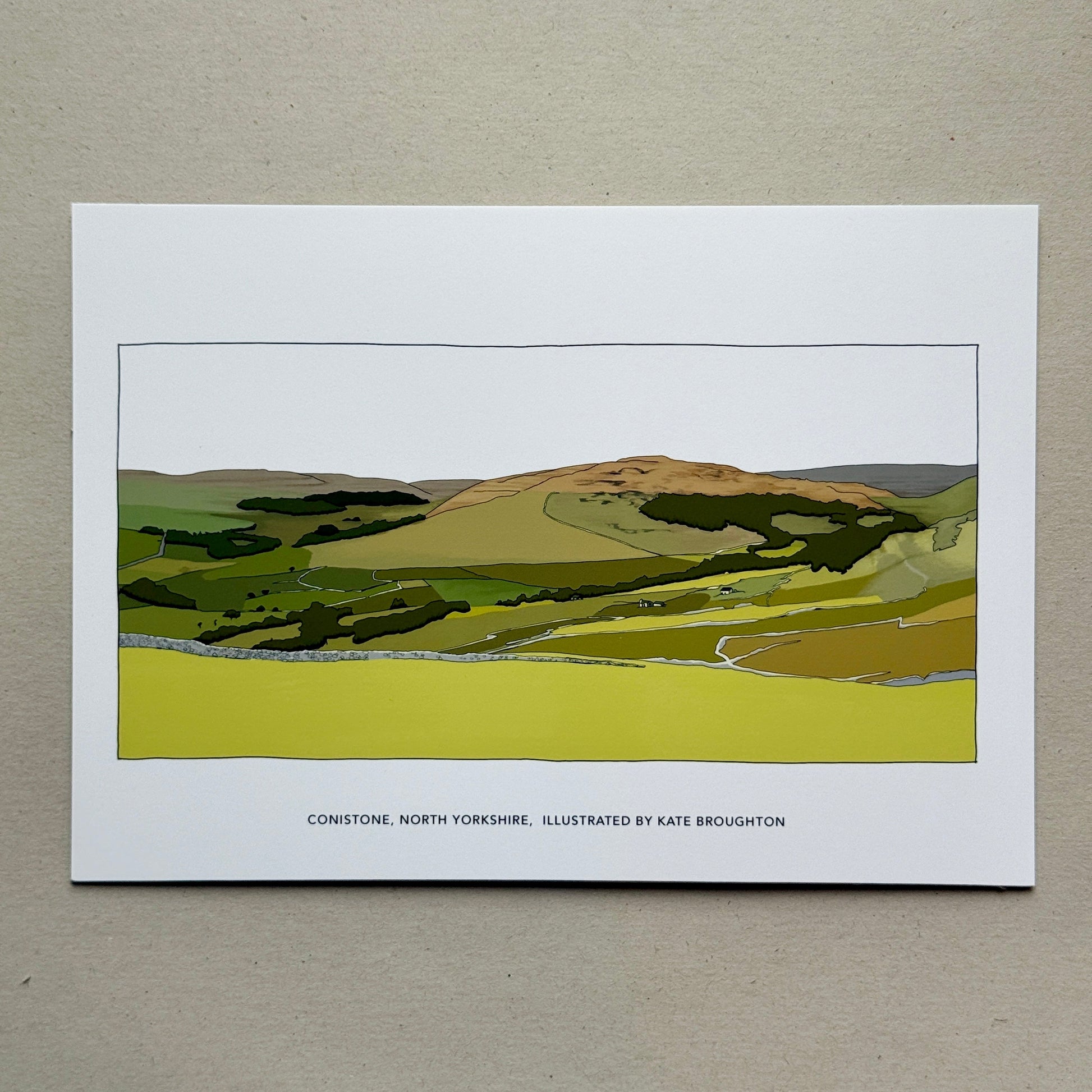 Art print of a landscape with green fields and a hill on a beige background. Labelled Conistone, North Yorkshire