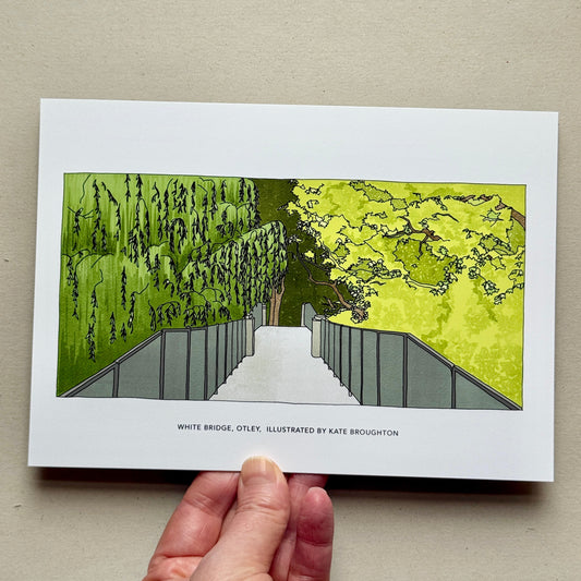 Hand holding a print with an illustration of the white bridge in Otley by Kate Broughton