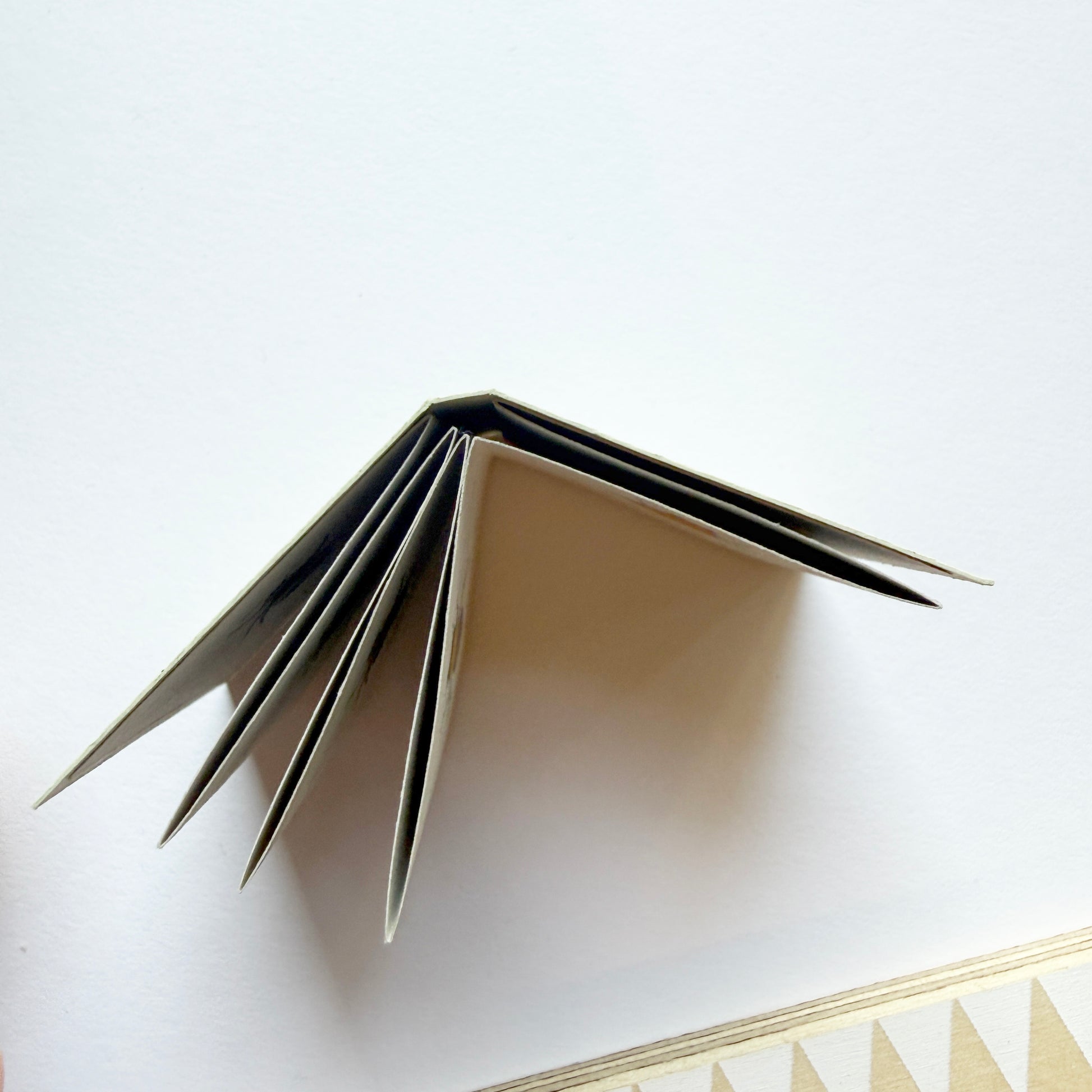 handmade Tiny Book viewed from above, showing folded pages Kate broughton