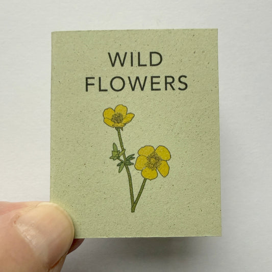 Miniature handmade book with 'Wild Flowers' text and illustrations 