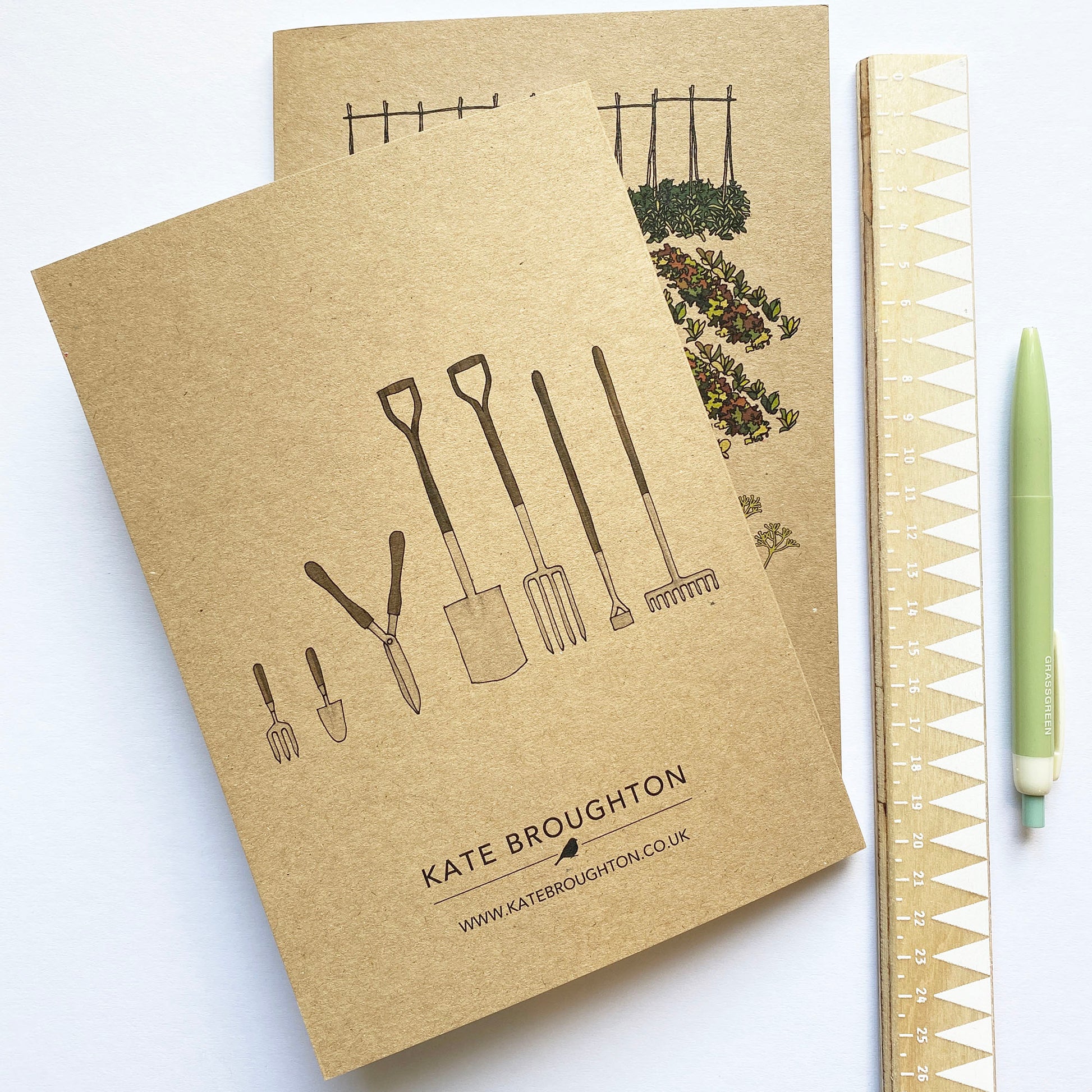 notebook with illustration of garden tools on the back cover