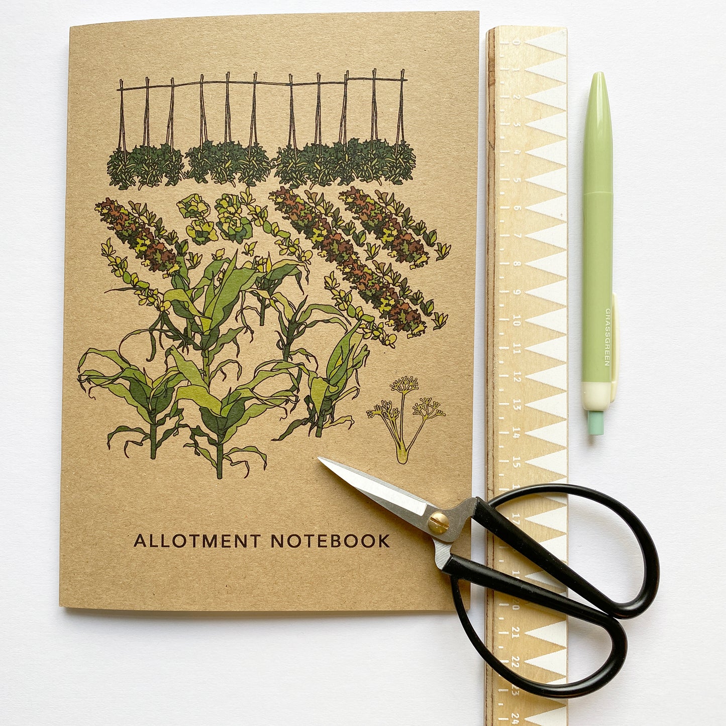 allotment notebook laid out with ruler, pen and garden scissors