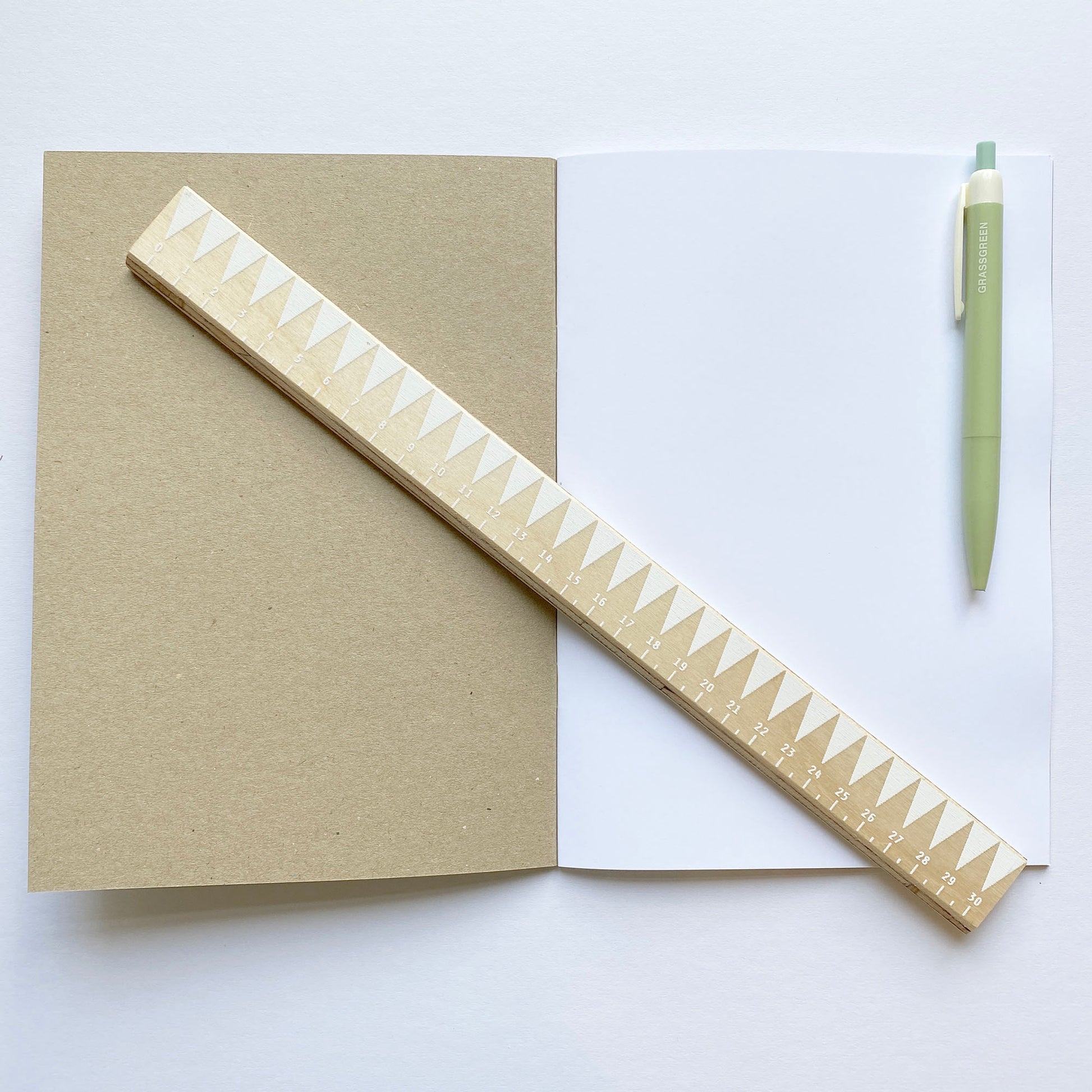 opened notebook with ruler and pen to show scale